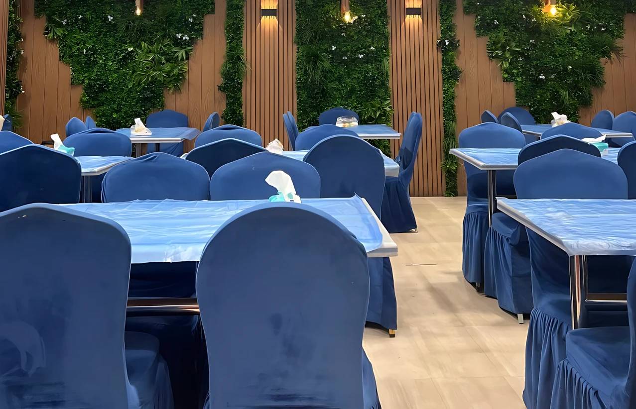 Elegant dining area at Zaitoon Restaurant Madinah with blue decor.