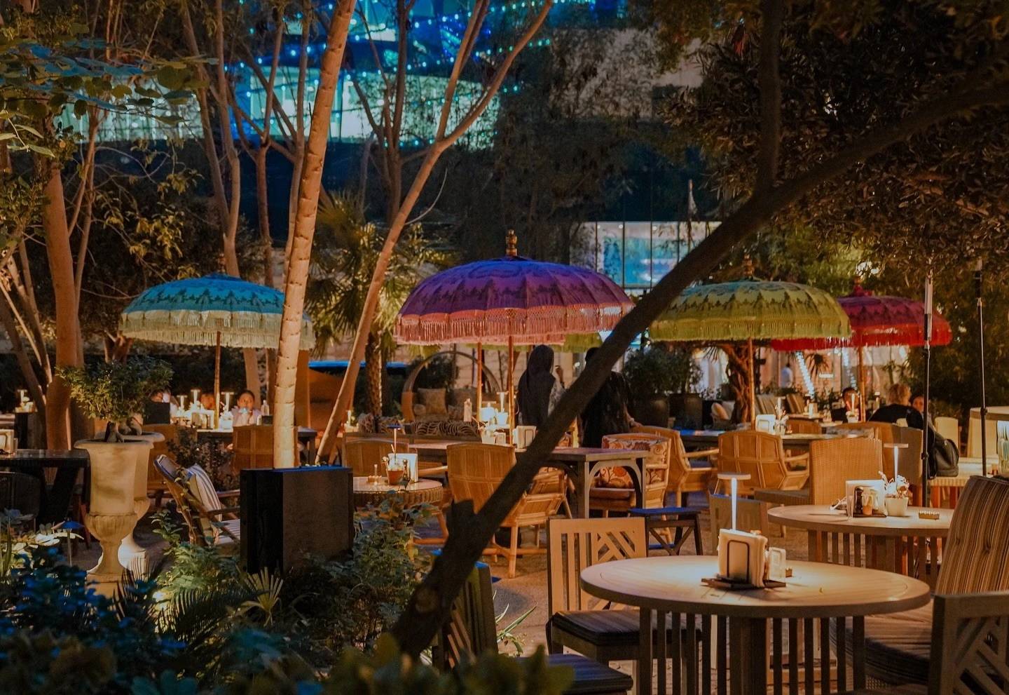 Twisted Olive & Naama’s Garden outdoor seating with colorful umbrellas, Doha.