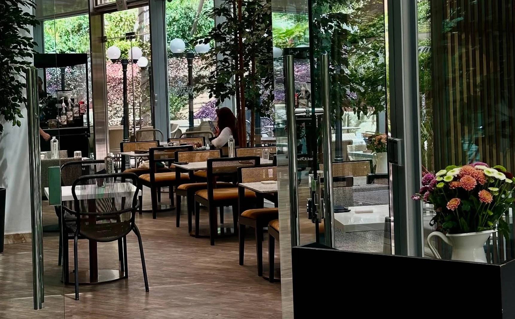Twisted Olive & Naama’s Garden seating area with flowers, Doha.