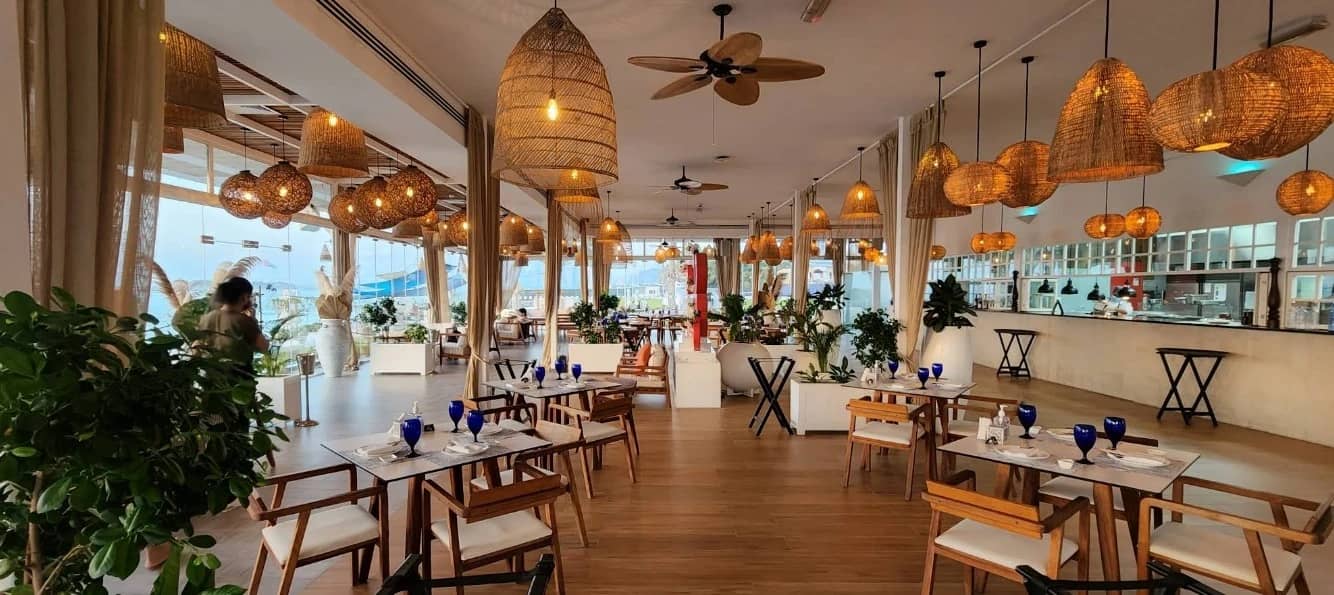 Elegant dining area at West Bay Lounge, Abu Dhabi, with wicker lights.