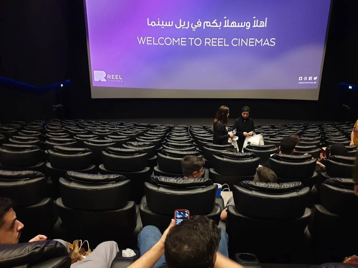 Reel Cinemas auditorium with seated audience, Dubai Marina Mall.