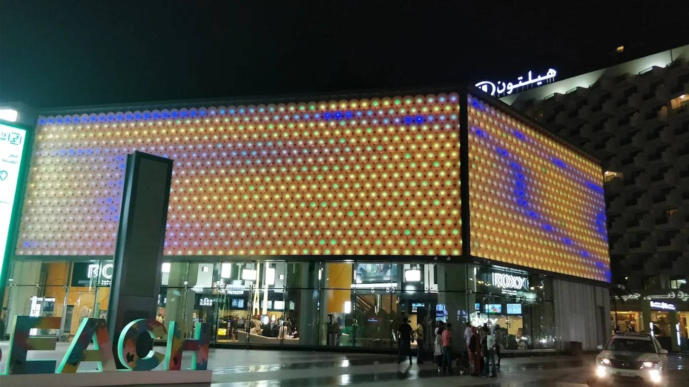 Reel Cinemas at Dubai Marina Mall illuminated at night.