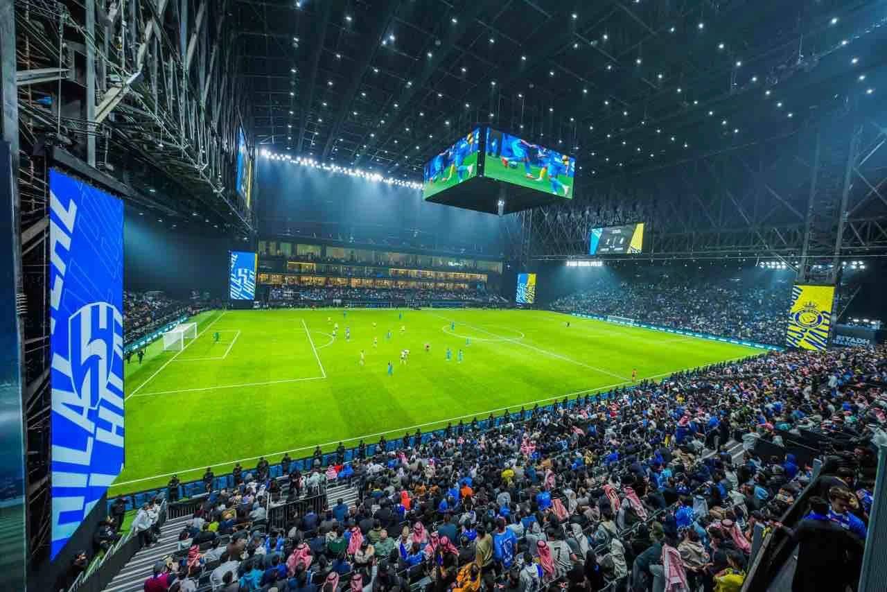 Crowded Kingdom Arena Riyadh during a nighttime soccer match.