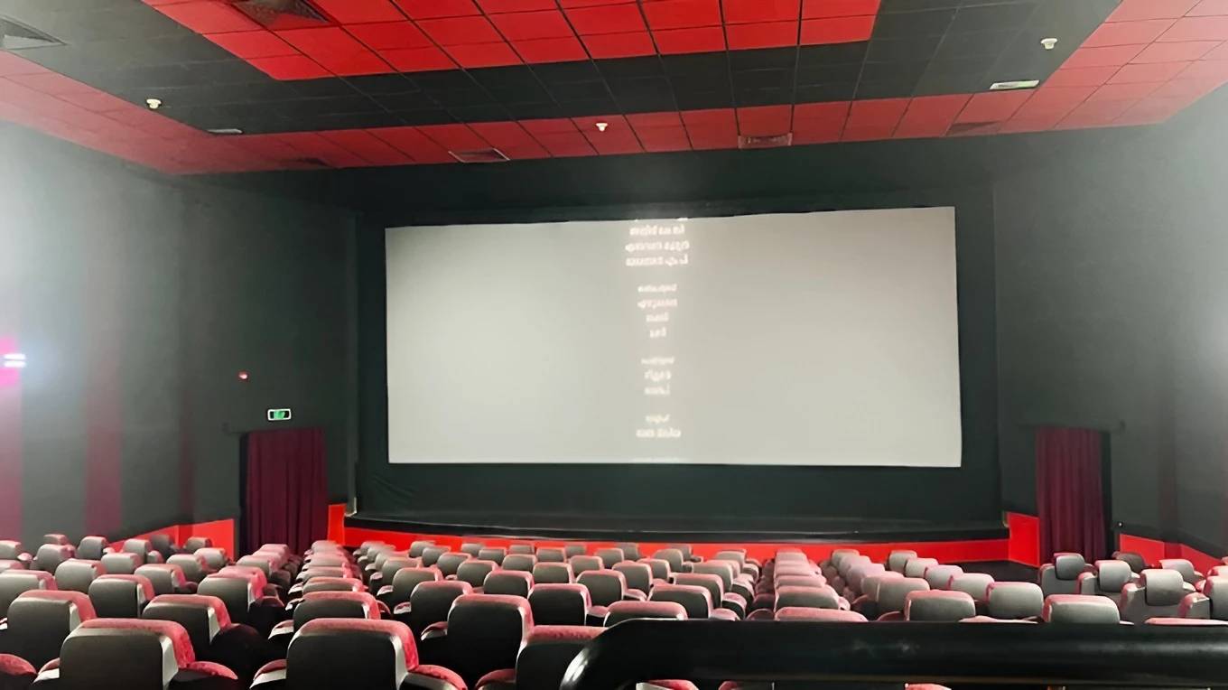 Empty theater at Gulf Cinema Ras Al Khaimah, red seats, large screen.