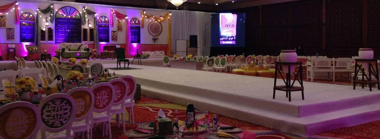 Regency Hall Doha decorated for an elegant event with stage and seating.