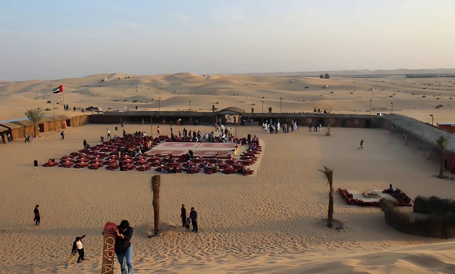 Al Khatim Desert Safari venue with seating, Abu Dhabi desert backdrop.