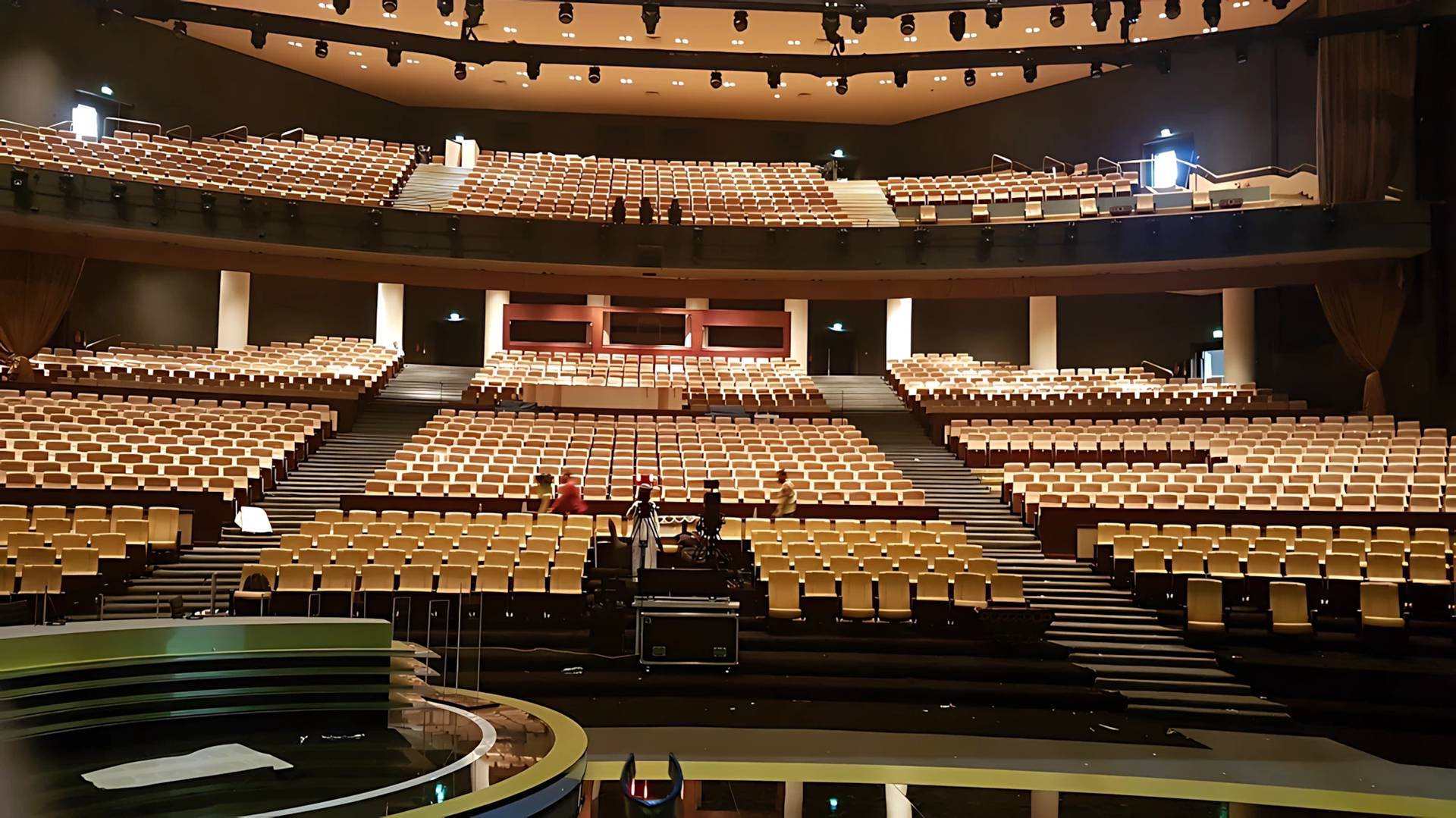 Empty seating inside National Theatre Abu Dhabi, spacious and well-lit.