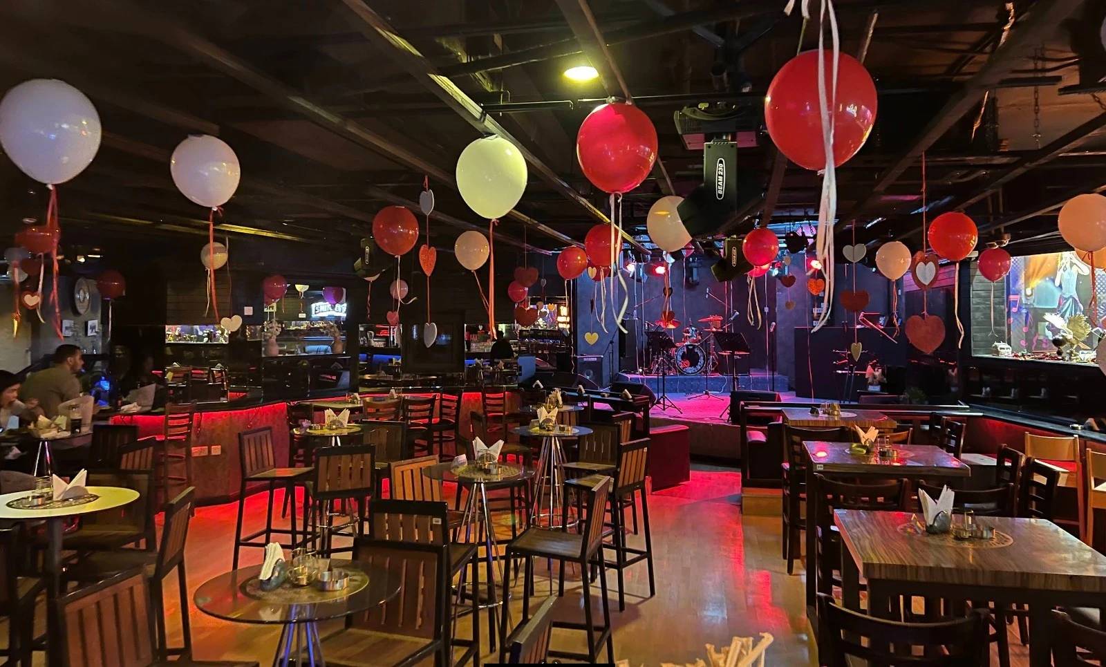 Decorated Maharlika Night Club in Doha with balloons and stage.