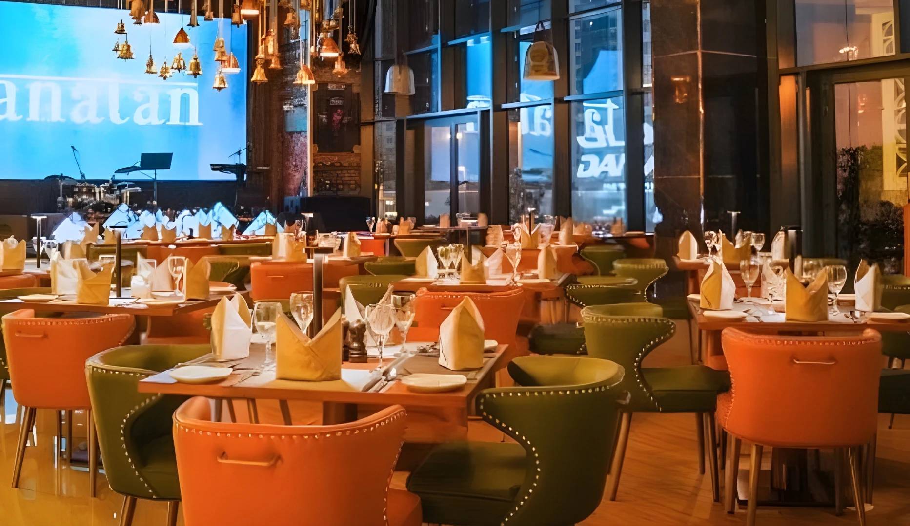 Elegant dining setup at Tanatan Dubai with colorful chairs.