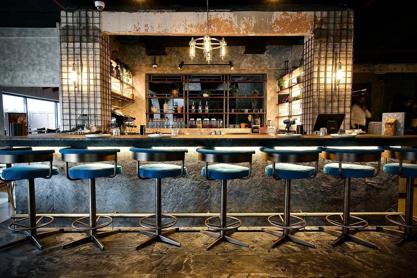 Stylish bar interior at 11 Woodfire Restaurant, Dubai.