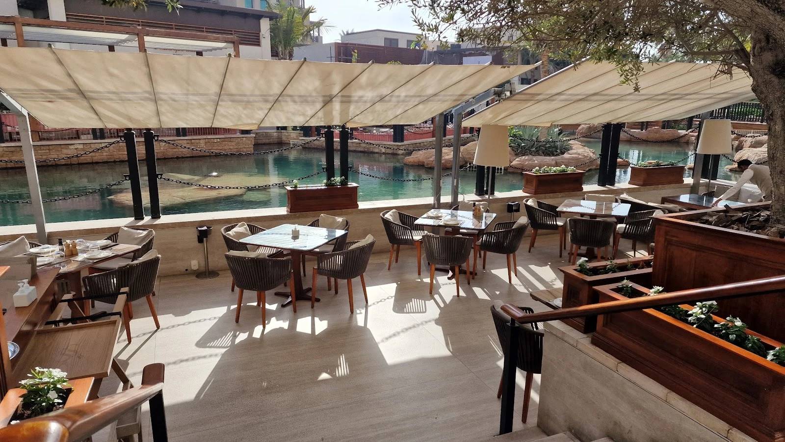 Outdoor seating at Il Borro Tuscan Bistro Dubai by water.