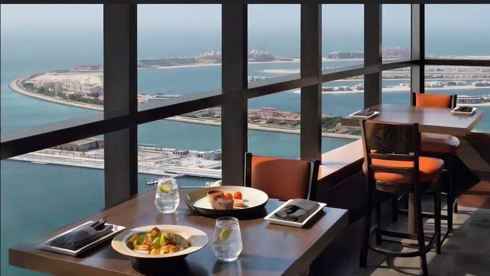 Dining tables with sea view at Observatory Lounge, Dubai, UAE