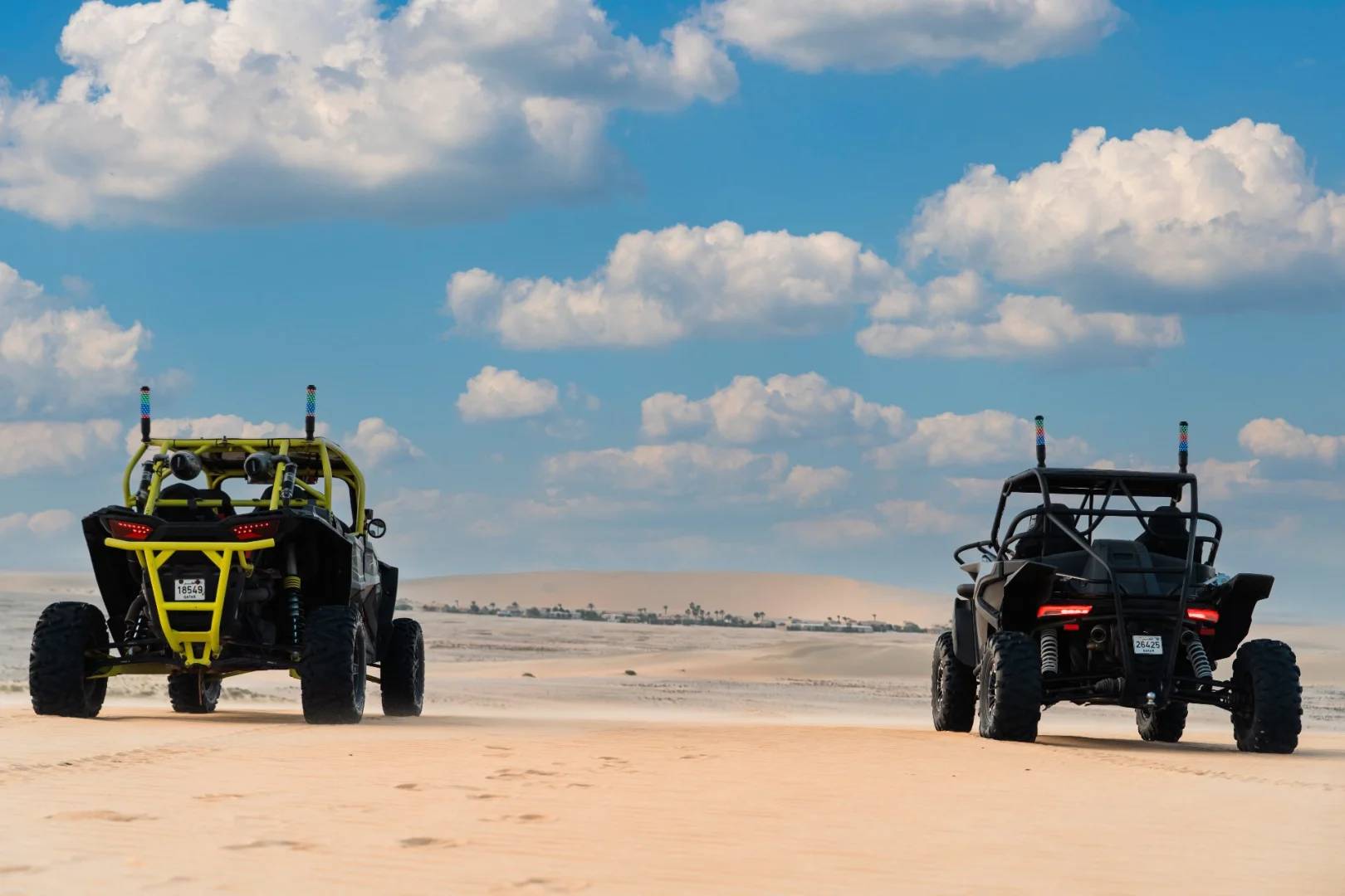 Two off-road vehicles on desert terrain at The Outpost Al Barari, Doha, QATAR.