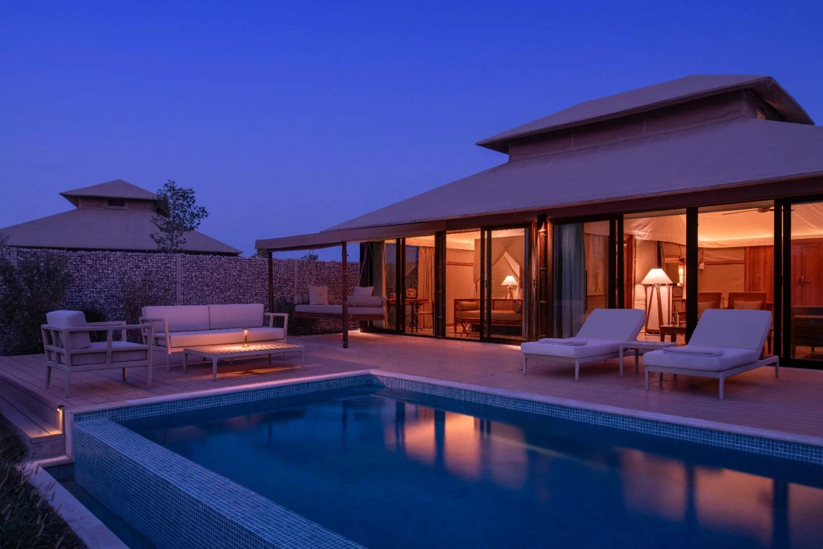 Outdoor pool and seating area at The Outpost Al Barari, Doha, QATAR