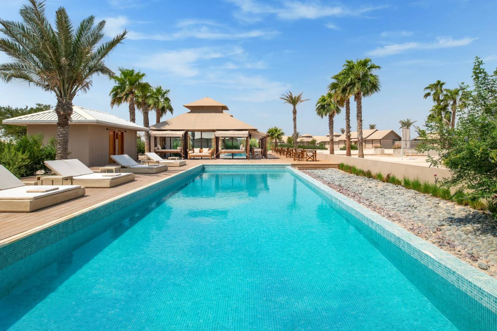 Outdoor pool and lounge area at The Outpost Al Barari, Doha, QATAR
