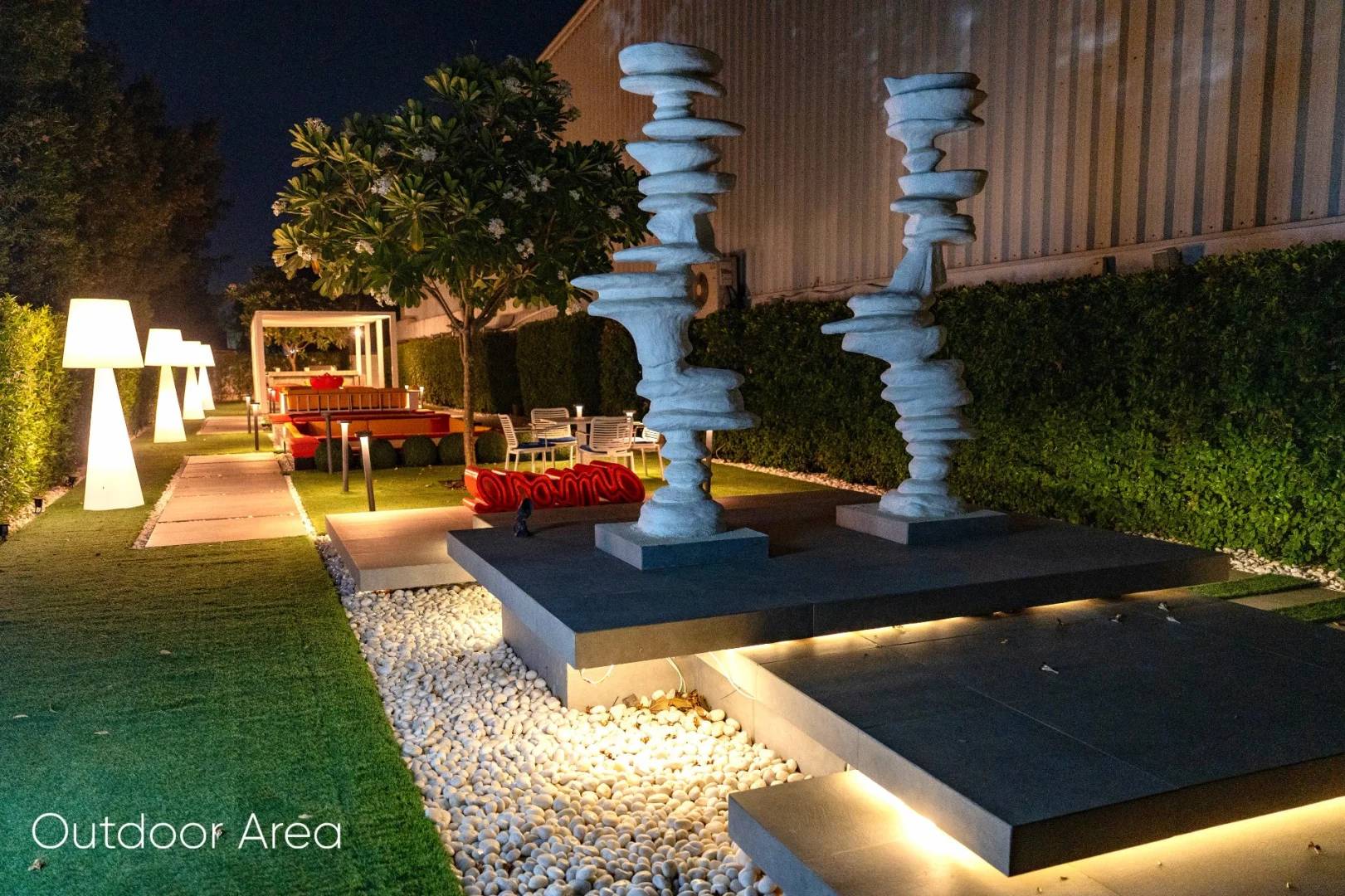 Illuminated outdoor sculptures and seating area at Aureum Club, Dubai, UAE