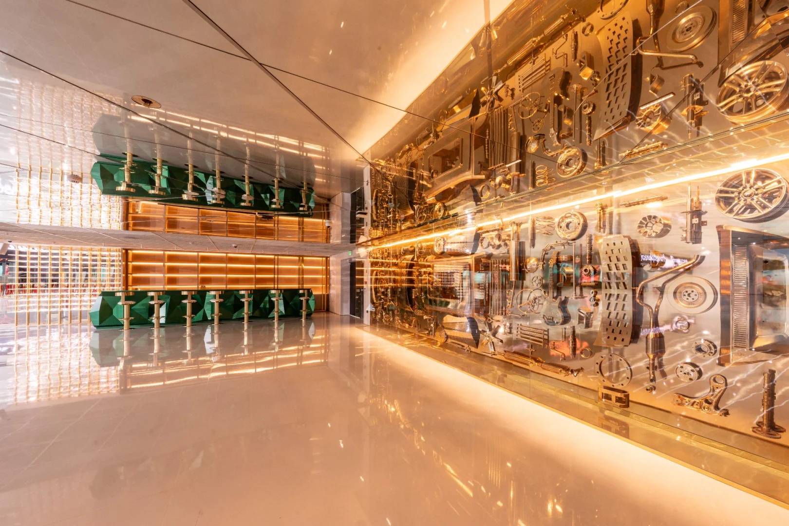 Modern interior with gold accents and green seating at Aureum Club, Dubai, UAE.