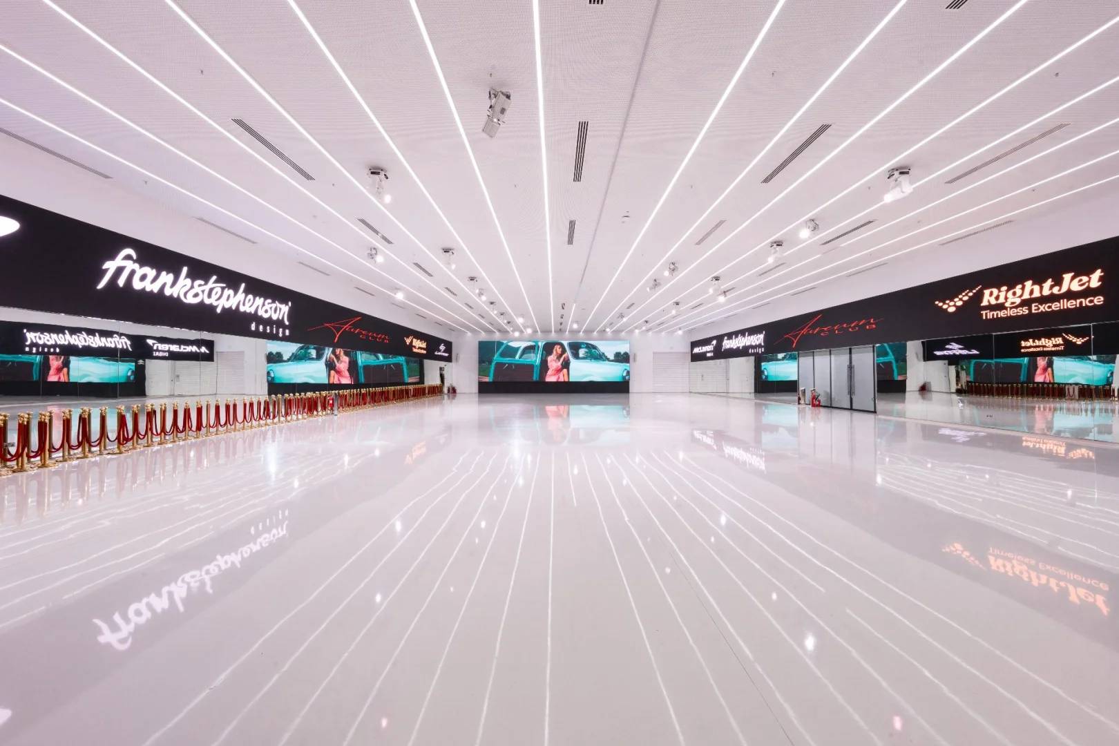 Spacious, modern event hall with digital displays at Aureum Club, Dubai, UAE.