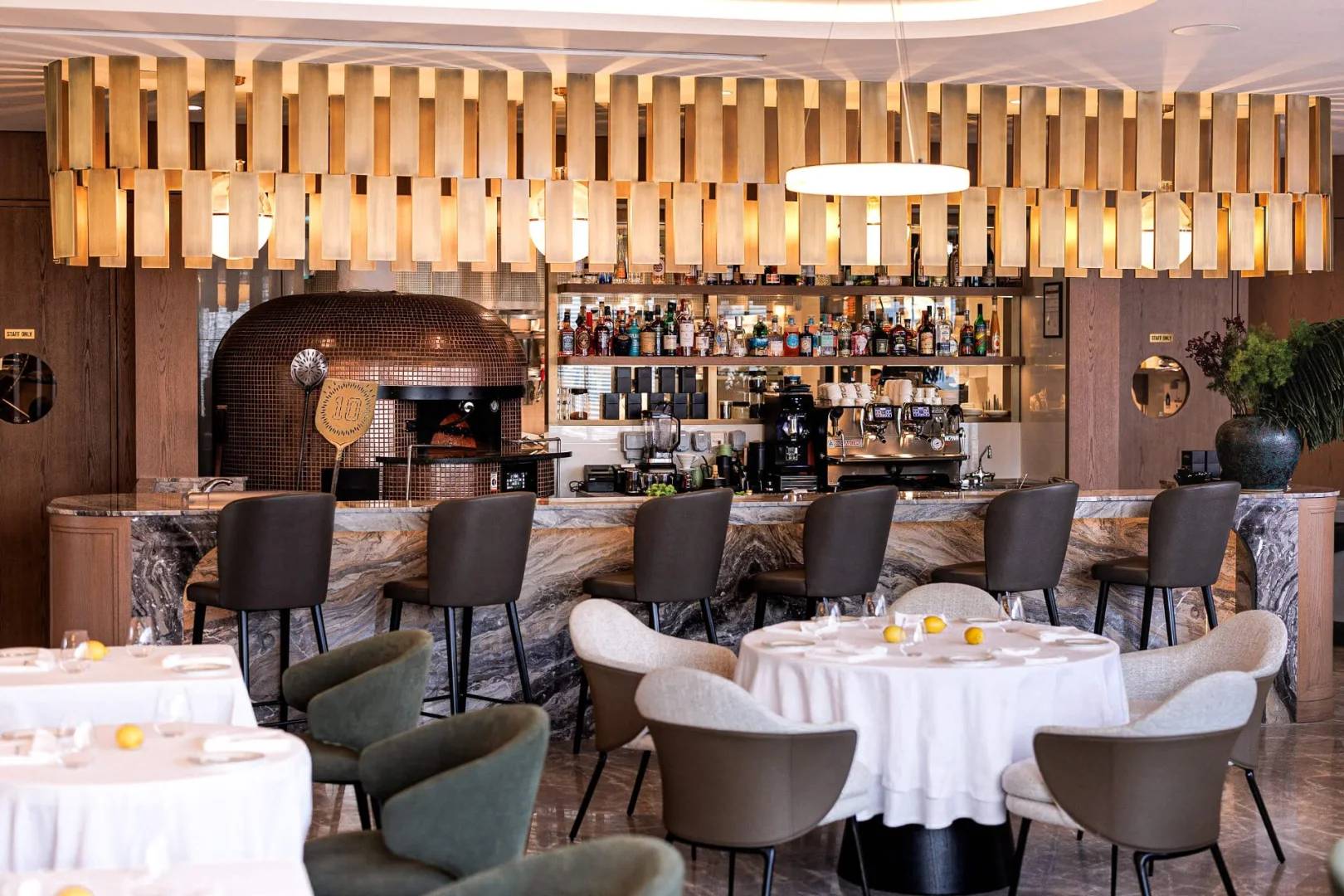 Elegant dining area with bar and pizza oven at LaFamiglia Dubai, Dubai, UAE.
