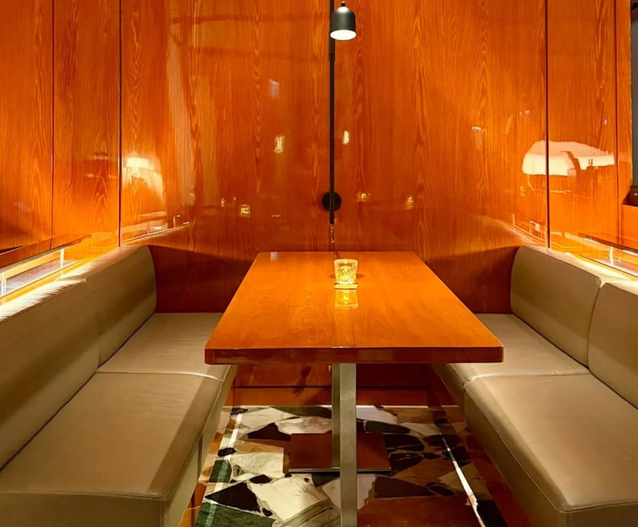 Cozy booth seating with wooden table at Coffeemania Dubai Hills Mall, Dubai, UAE.
