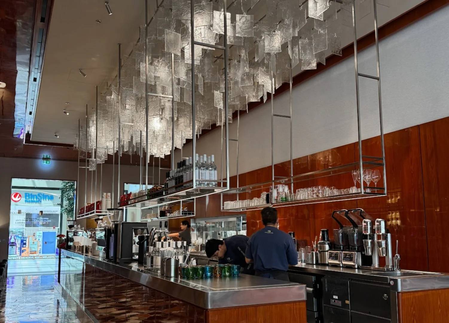 Modern bar area with hanging lights at Coffeemania Dubai Hills Mall, Dubai, UAE