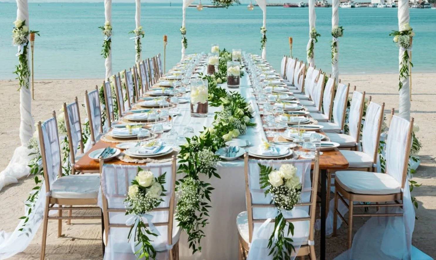 Beachfront dining setup with floral decor at Banana Island Resort Doha By Anantara.