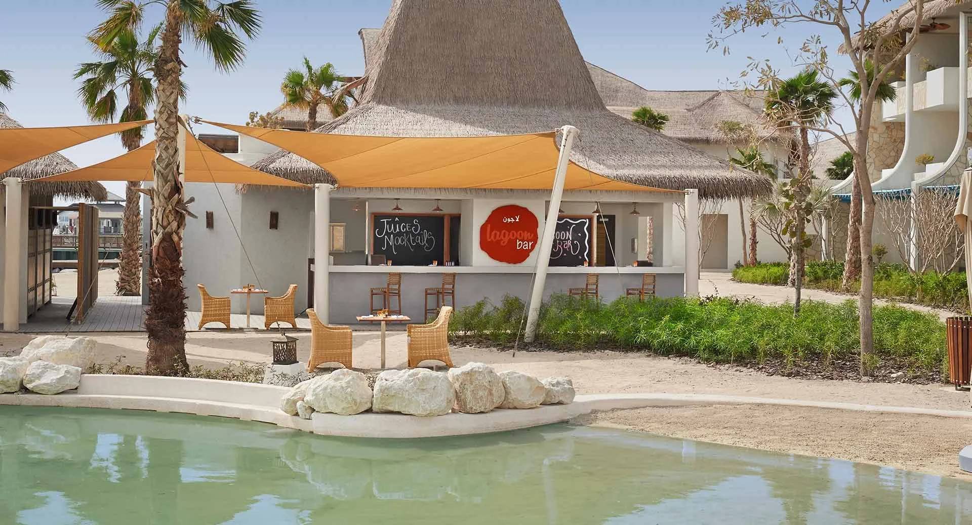 Outdoor seating and lagoon bar at Banana Island Resort Doha By Anantara, Doha.