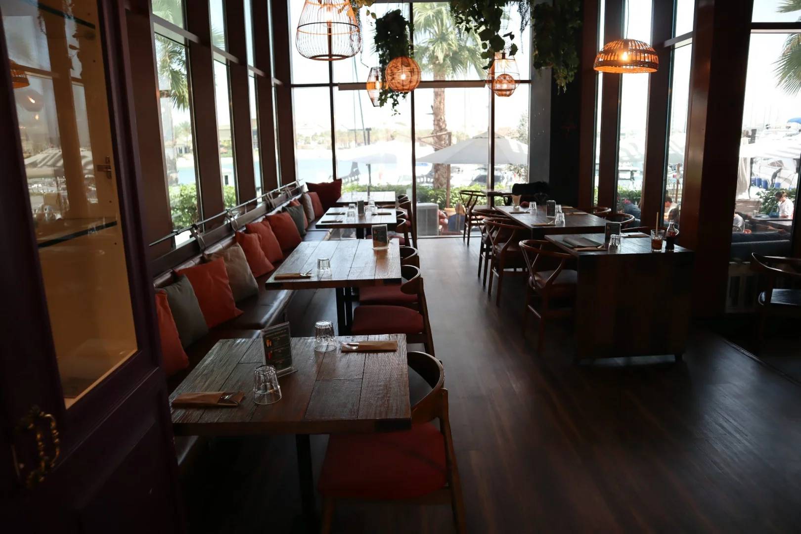 Cozy dining area with wooden tables at Ella's Eatery Restaurant Dubai, UAE