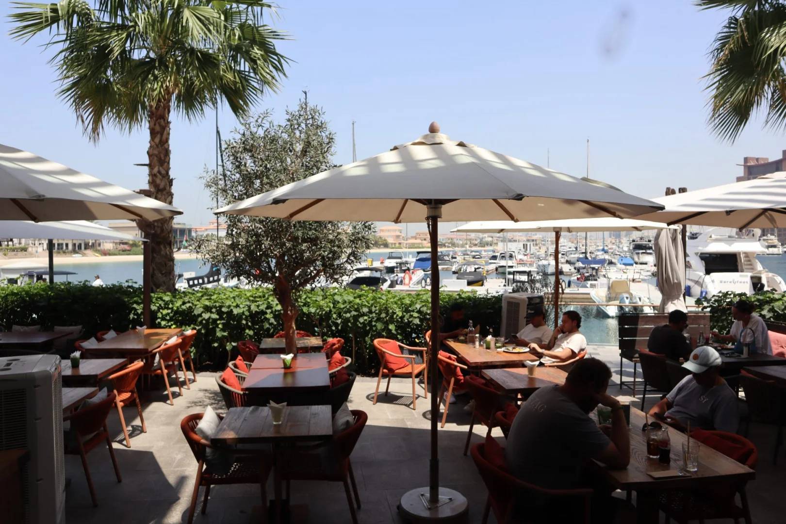 Outdoor dining area with umbrellas at Ella's Eatery Restaurant Dubai, Dubai, UAE