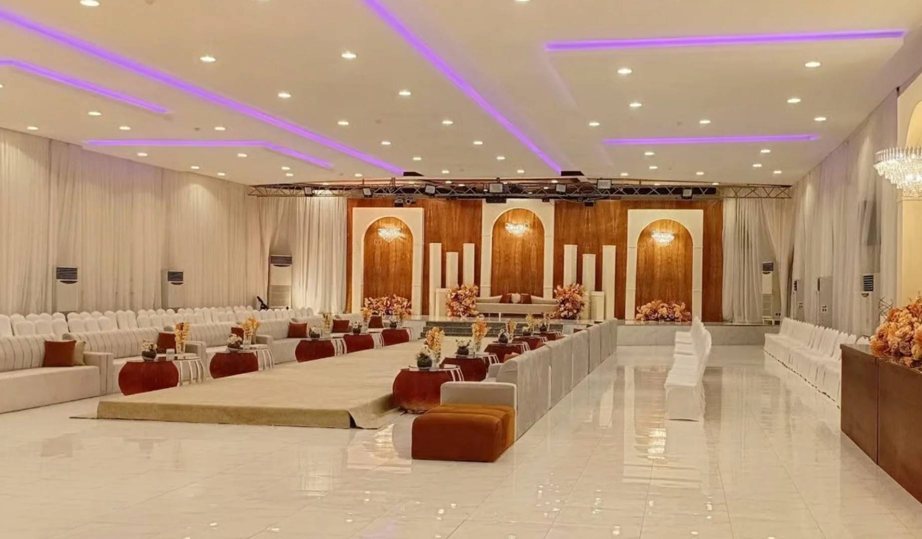 Elegant event space with seating and floral decor at Al Romansiah Wedding Venue Khafji.