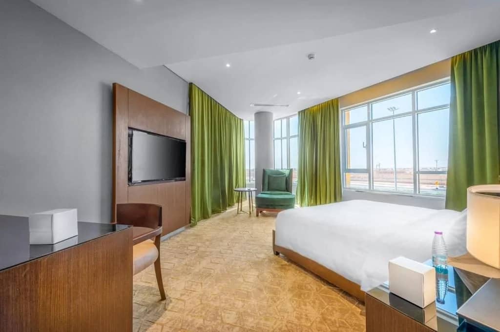 Spacious guest room with large windows at Sukani Royal Hotel Hail, Saudi Arabia.