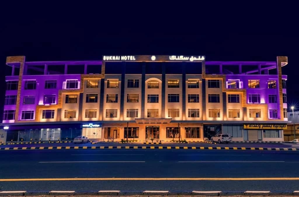 Illuminated exterior of Sukani Royal Hotel Hail, Hail, Saudi Arabia at night.