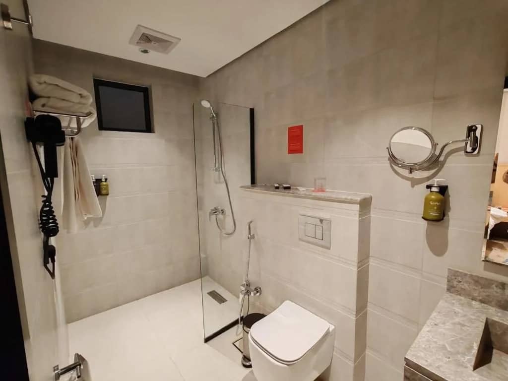 Modern bathroom with shower and amenities at Ayas Hotel Hail, Saudi Arabia.