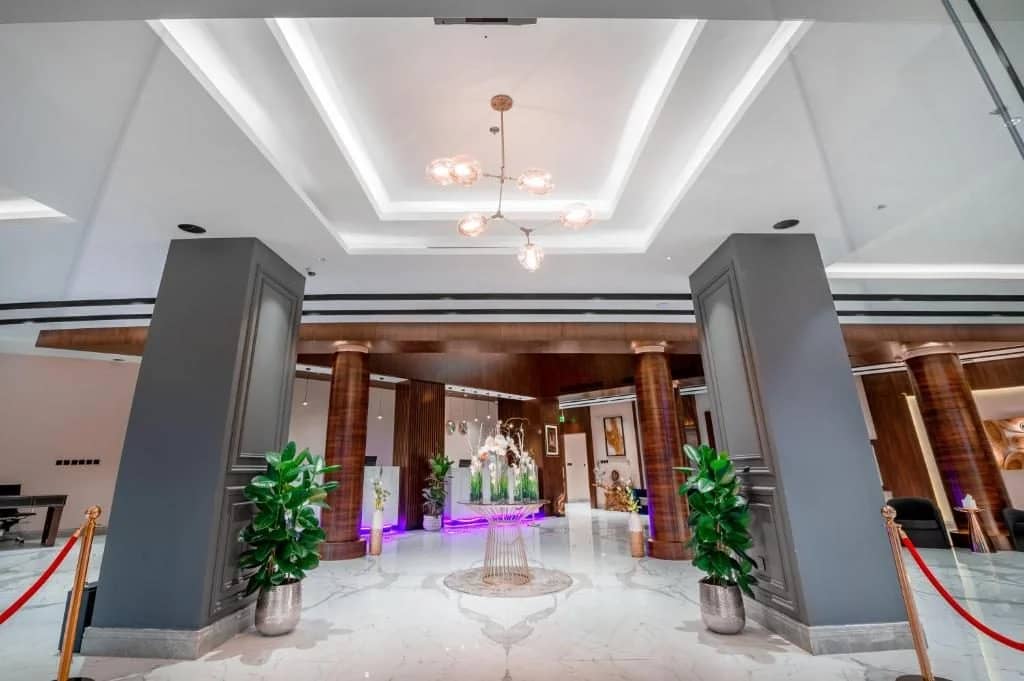 Elegant lobby with plants and modern lighting at Sukani Royal Hotel Hail, Saudi Arabia