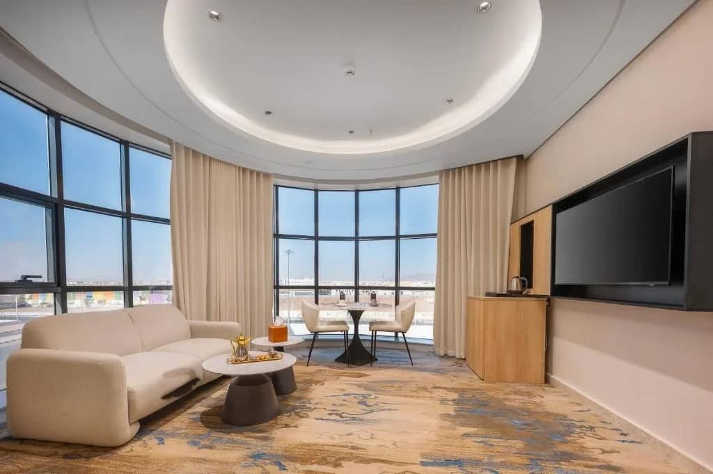 Elegant guest room with seating area at Ayas Hotel Hail, Saudi Arabia.