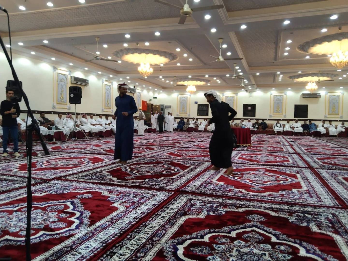 Spacious event hall with patterned carpets at Andalus Palace for Wedding Makkah, Saudi Arabia.