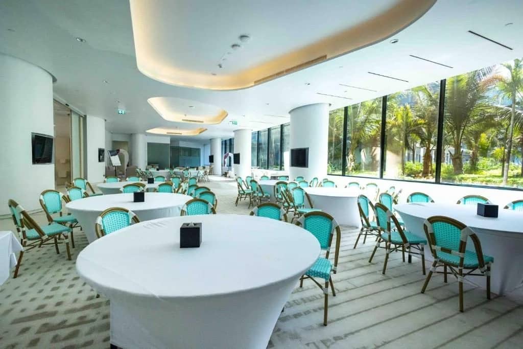 Spacious event room with round tables at Voco Dubai Nice, Dubai, UAE