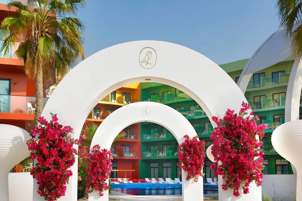 Floral archways and colorful building at Voco Dubai Nice The Heart of Europe, Dubai.