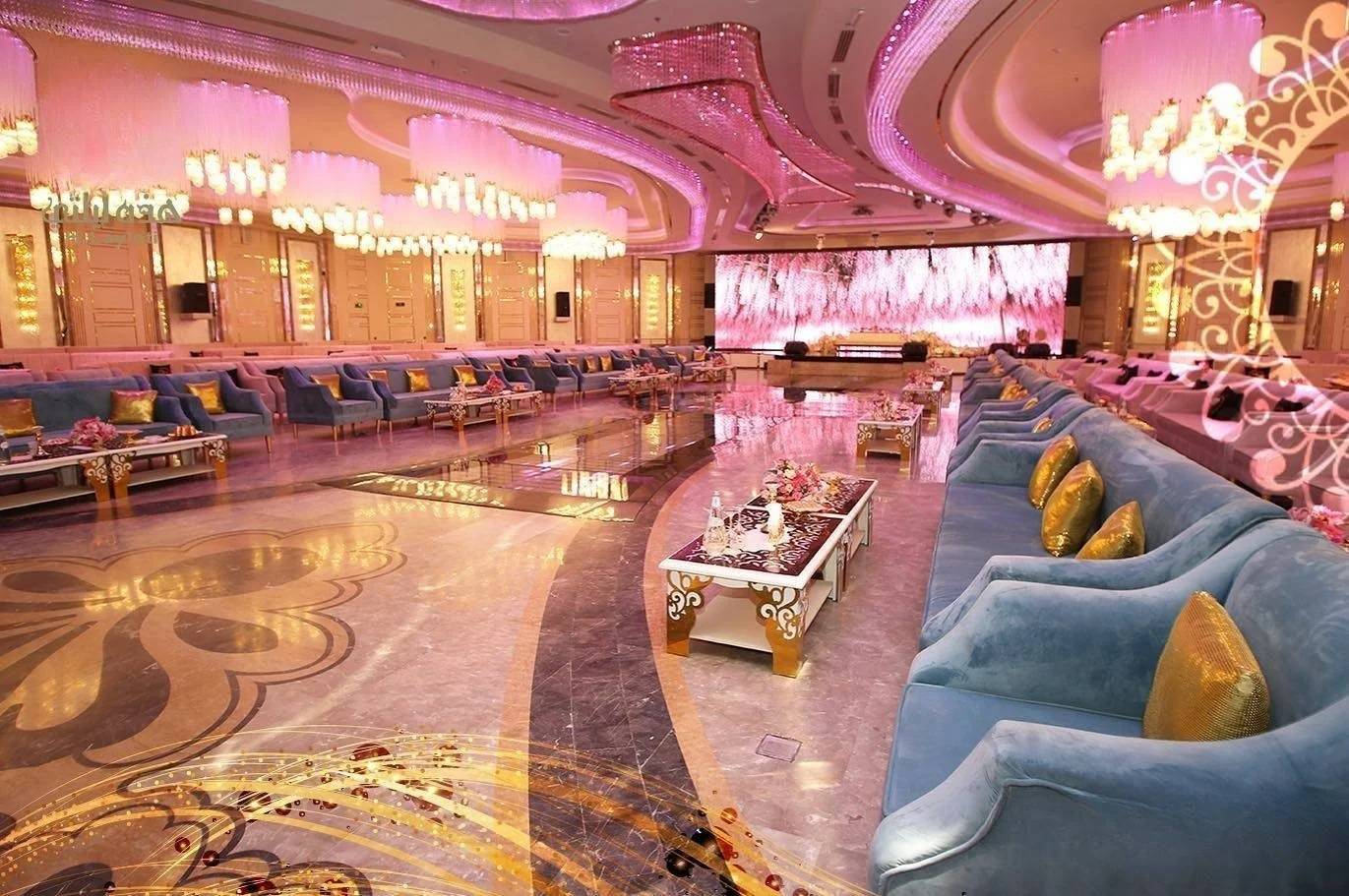 Luxurious event hall with chandeliers and seating at H Laylati Event Venue, Madinah.