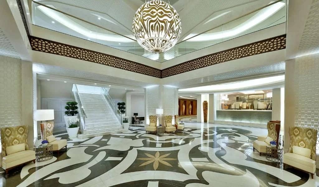 Elegant lobby with patterned floor and seating at Conrad Makkah, Makkah, Saudi Arabia.