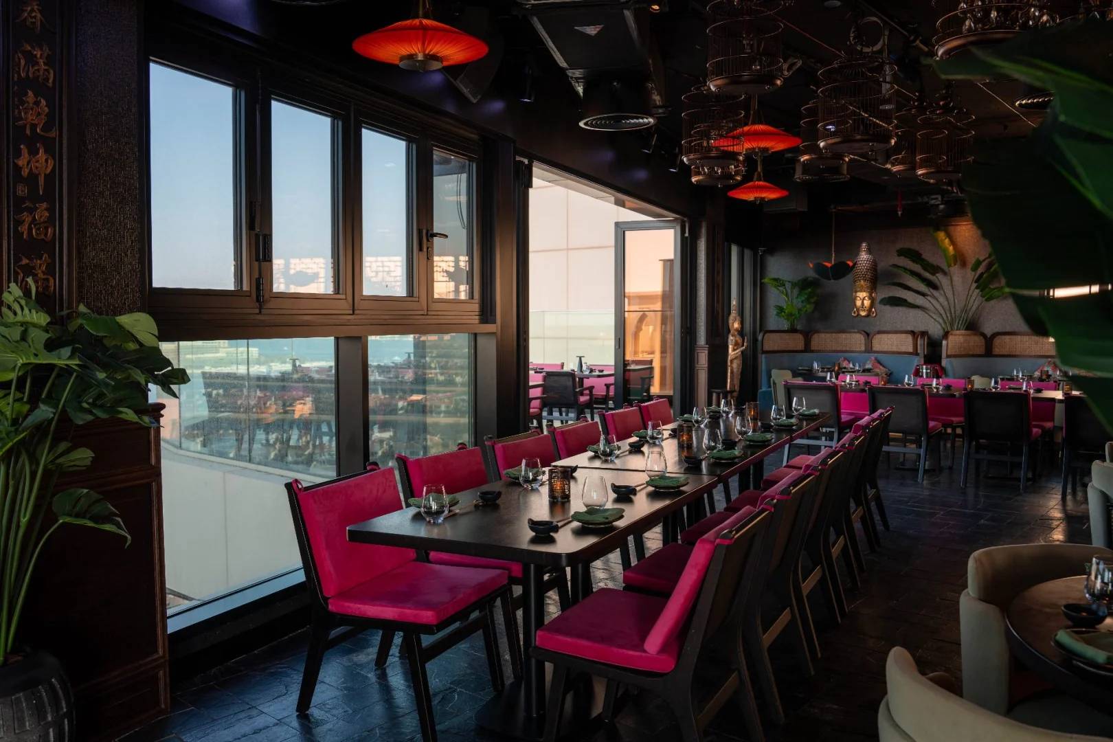 Elegant dining area with large windows at Asia Asia The Palm, Dubai, UAE.