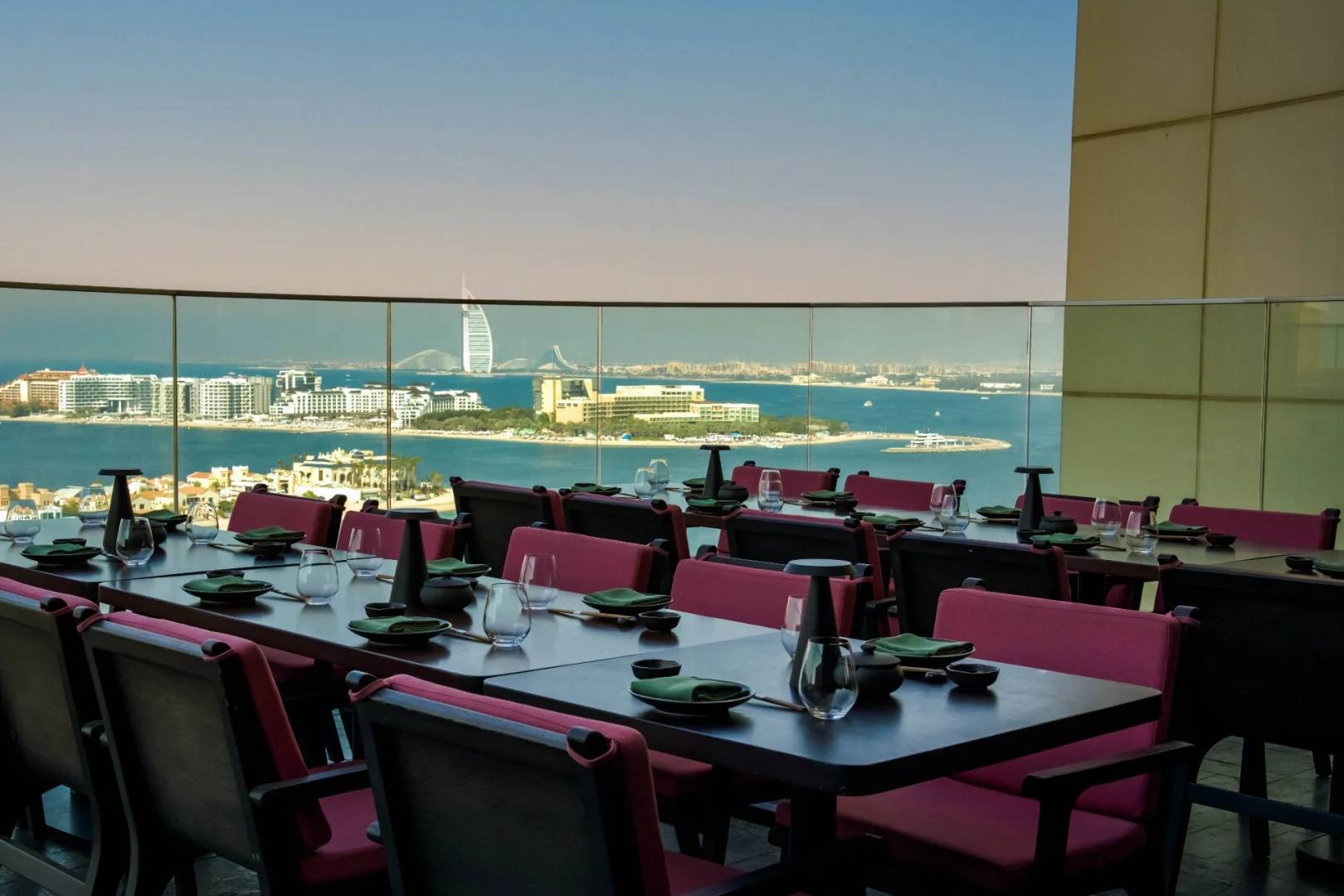 Outdoor dining area with sea view at Asia Asia The Palm, Dubai, UAE.