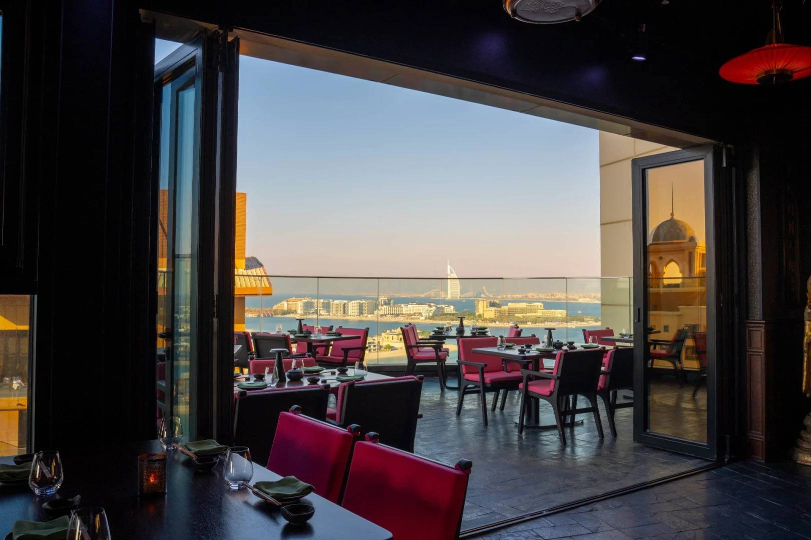 Outdoor dining area with city view at Asia Asia The Palm, Dubai, UAE