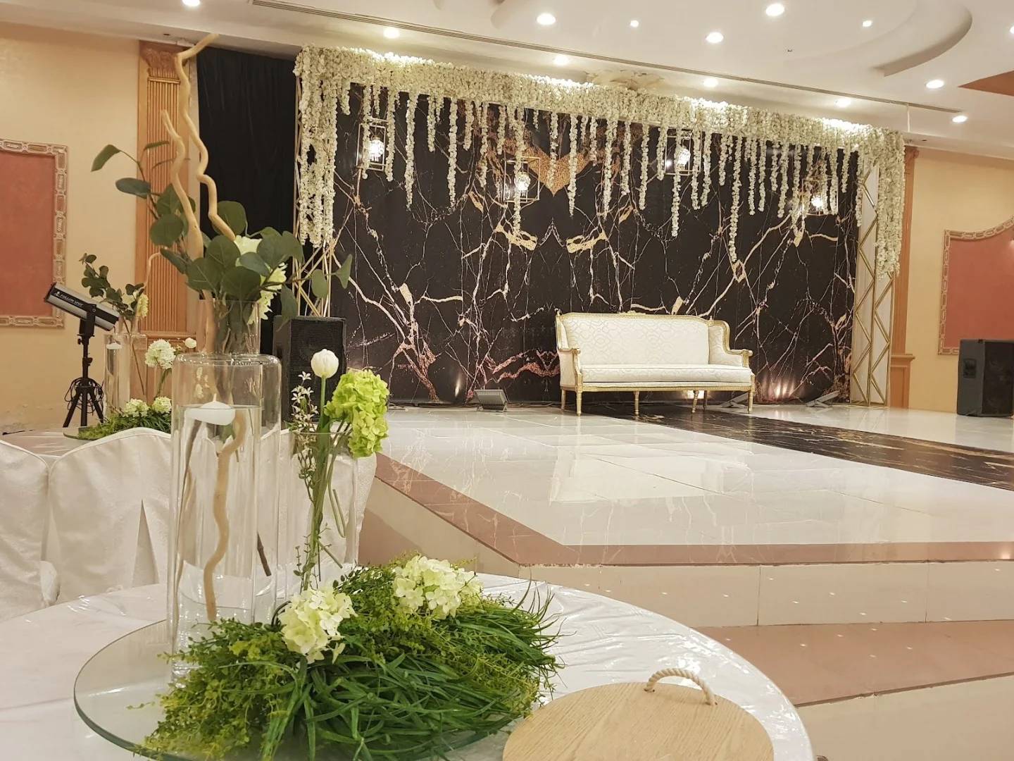 Elegant stage with floral decor at Sadeem Celebrations Hall Abha, Saudi Arabia.