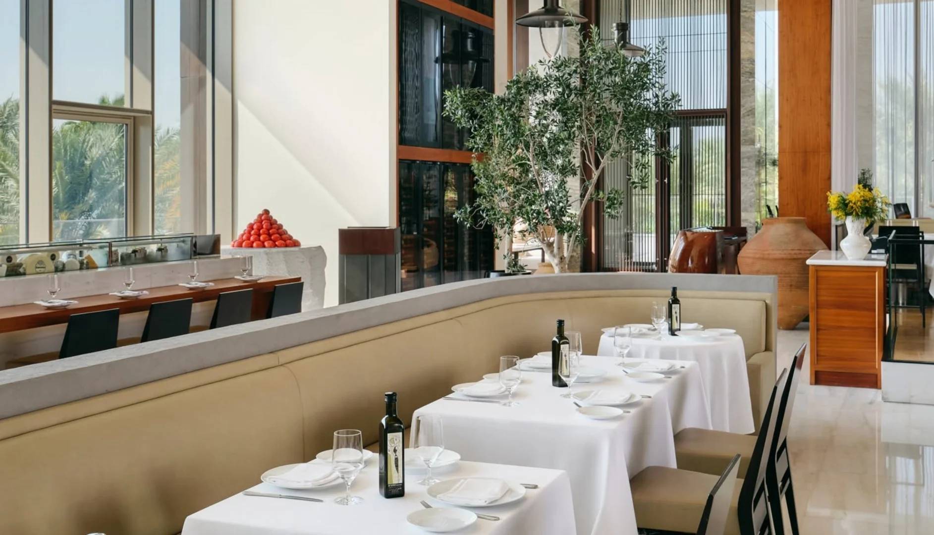 Elegant dining area with white tablecloths at Estiatorio Milos Dubai, Dubai, UAE.
