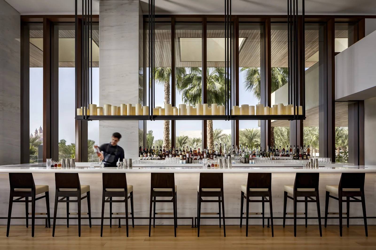 Elegant bar area with bartender at Estiatorio Milos Dubai, Dubai, UAE