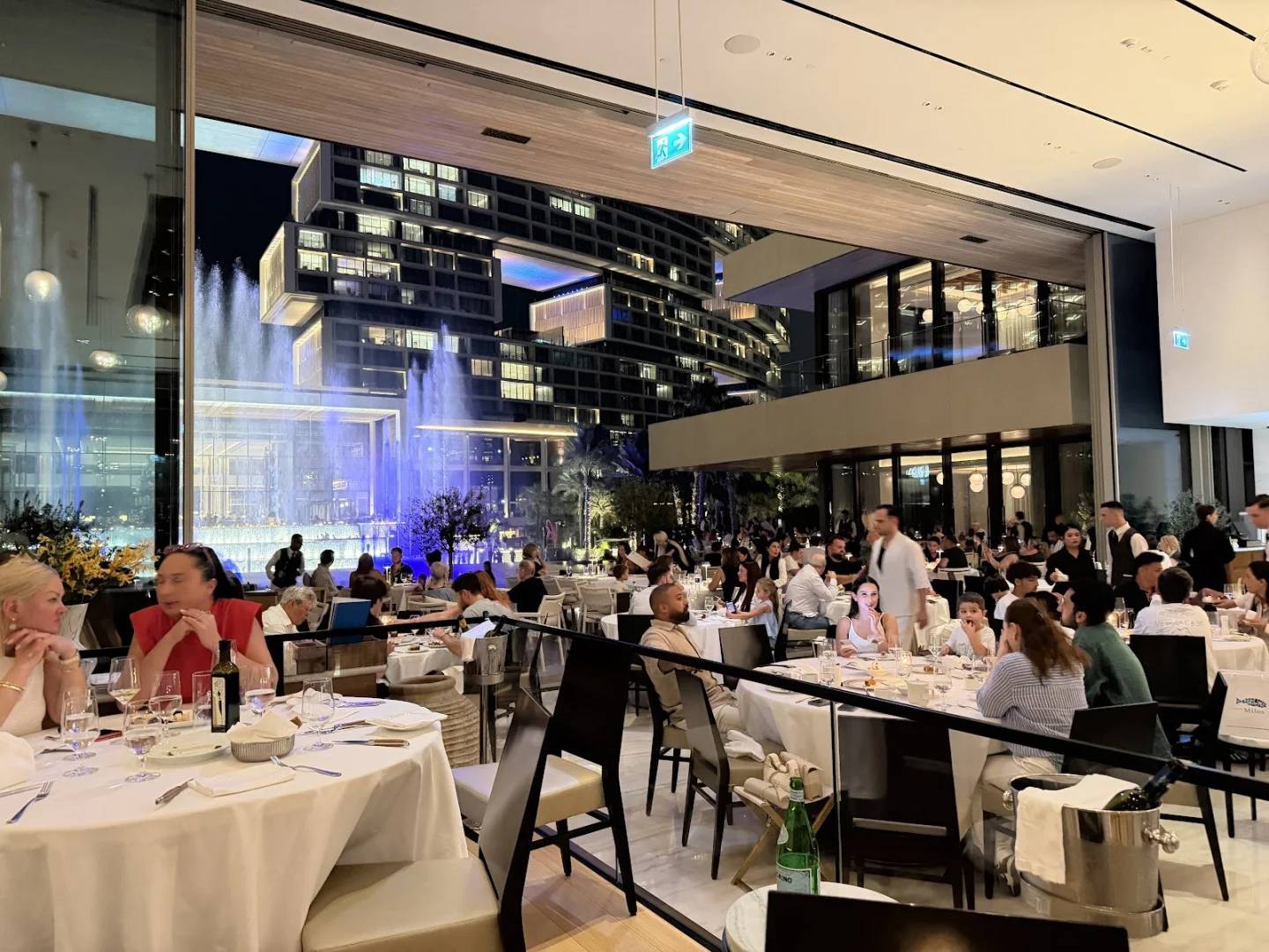 Elegant dining area with large windows at Estiatorio Milos Dubai, UAE.