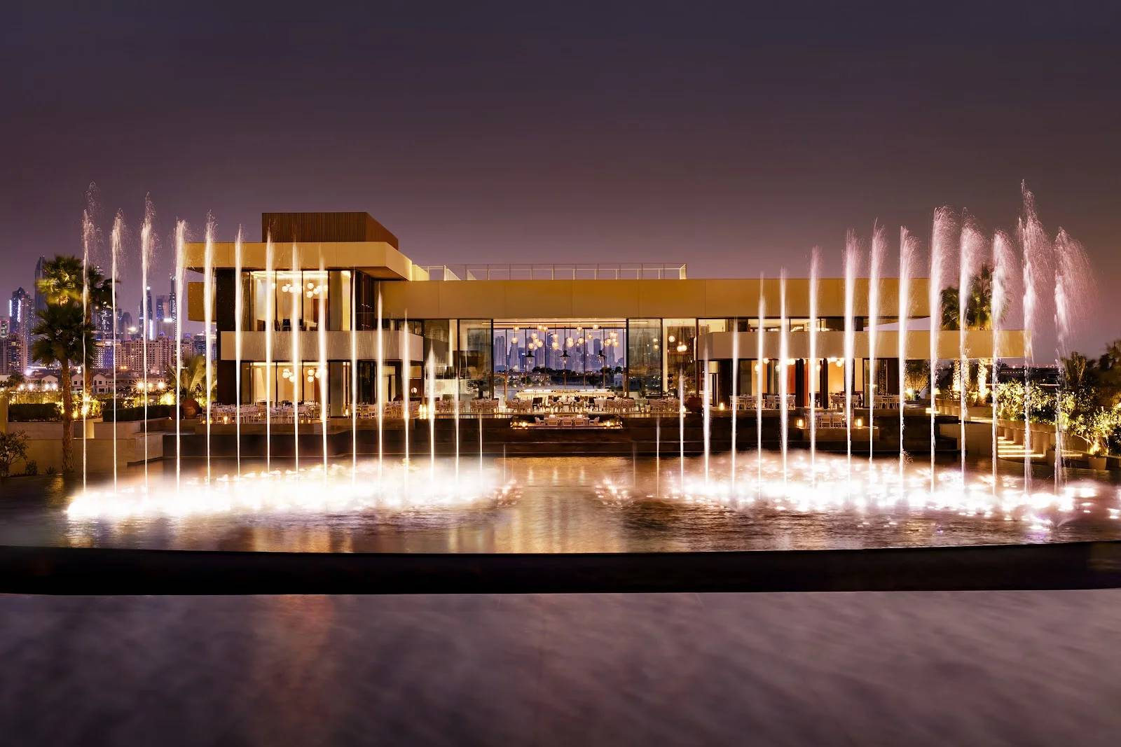 Illuminated fountains and modern architecture at Estiatorio Milos Dubai, Dubai, UAE