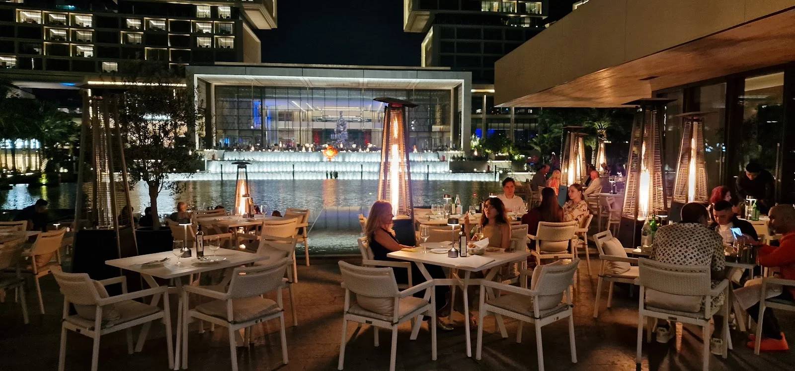 Outdoor dining area at Estiatorio Milos Dubai, Dubai, UAE with night lighting.