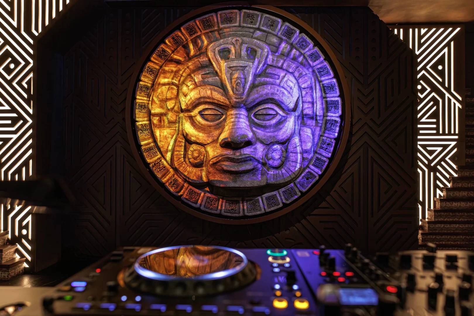 Decorative wall with Aztec face and DJ equipment at AMARU Dubai, UAE.